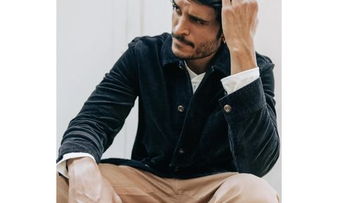 Man sitting in a green corduroy jacket.