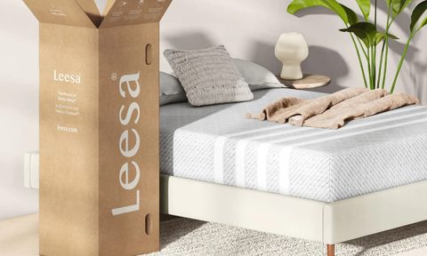 A Leesa mattress box and a Leesa mattress being used on a bed.
