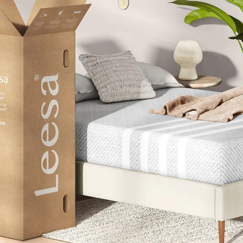 A Leesa mattress box and a Leesa mattress being used on a bed.