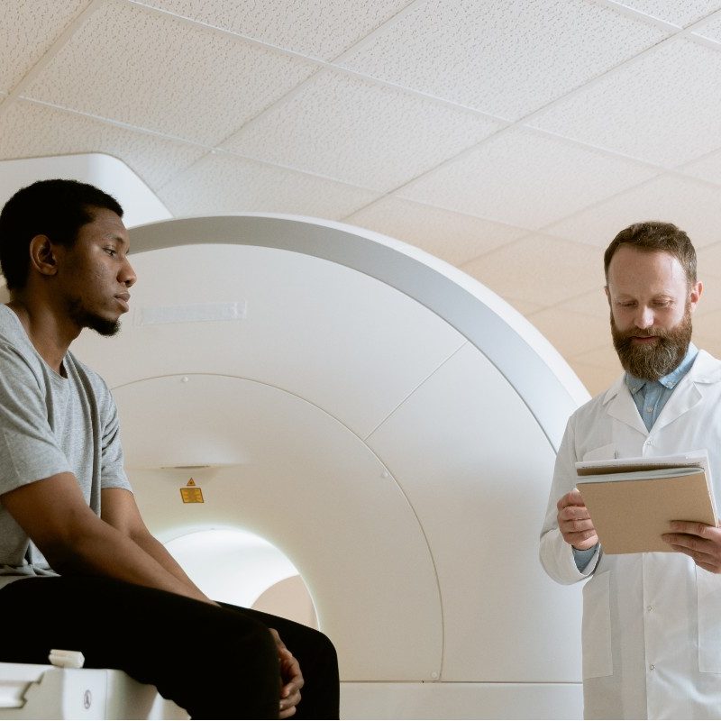 A male doctor talking to a male patient