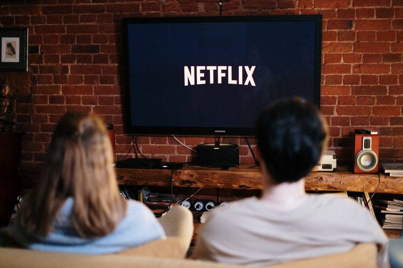 man and woman watching Netflix