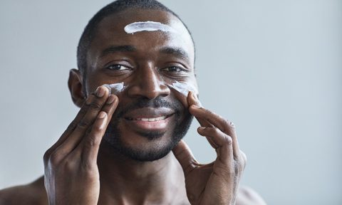 A man applying skin cream