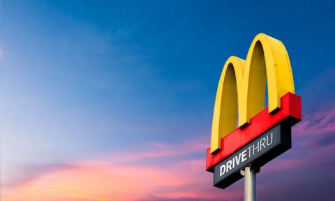 McDonalds iconic yellow arch with sunset.