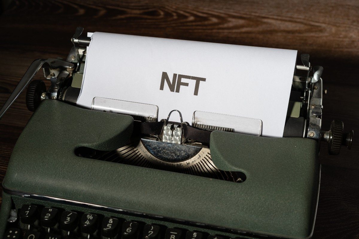 words NFT on a typewriter