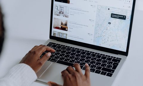 Woman looking at Airbnb on a laptop