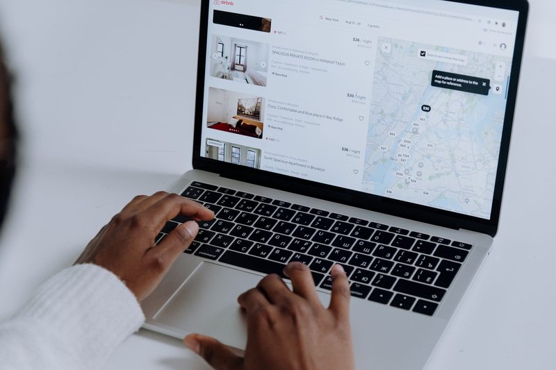 Woman looking at Airbnb on a laptop