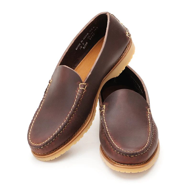 A pair of brown venetian slippers.