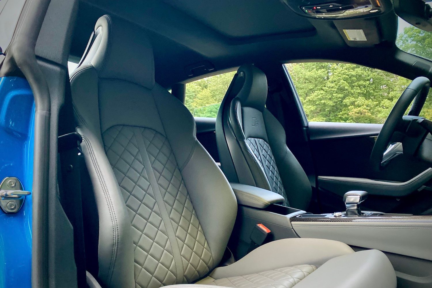 2023 Audi S5 Sportback close up of front passenger seat with trees in the back.