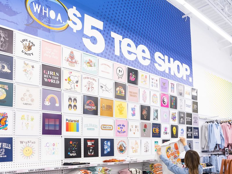 Five Below graphic tee selection wall in store.