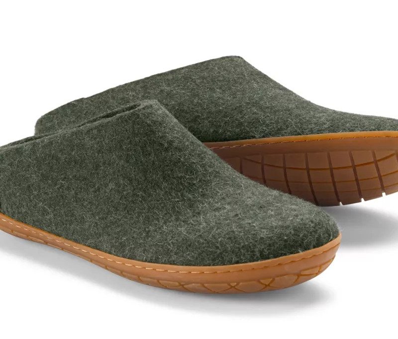 A pair of green felted wool slip on shoes.