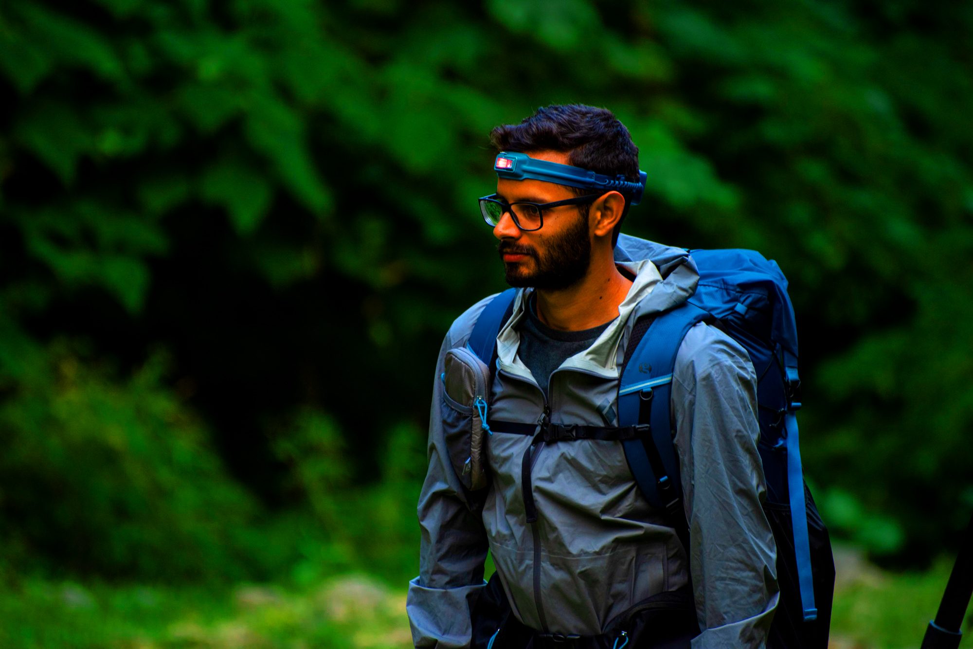 A man walks while wearing the BioLite HeadLamp 425