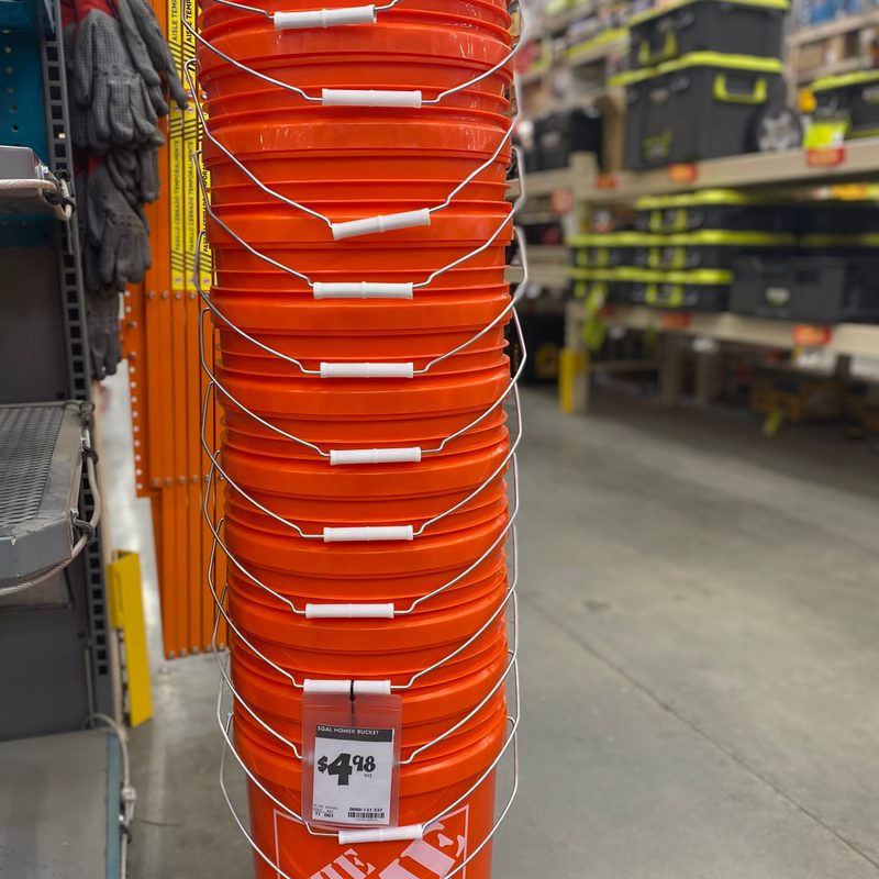 Stack of orange 5-gallon buckets
