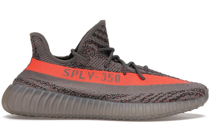 A pair of gray Yeezy sneakers with an orange stripe.