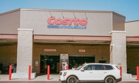 Costco storefront with car parked in front.
