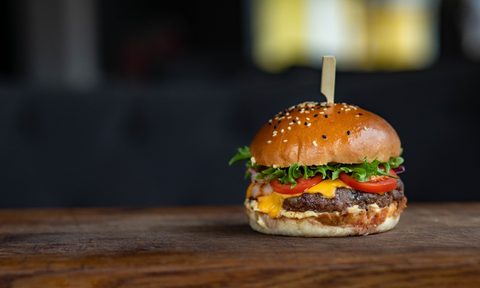 A hamburger on a wooden table