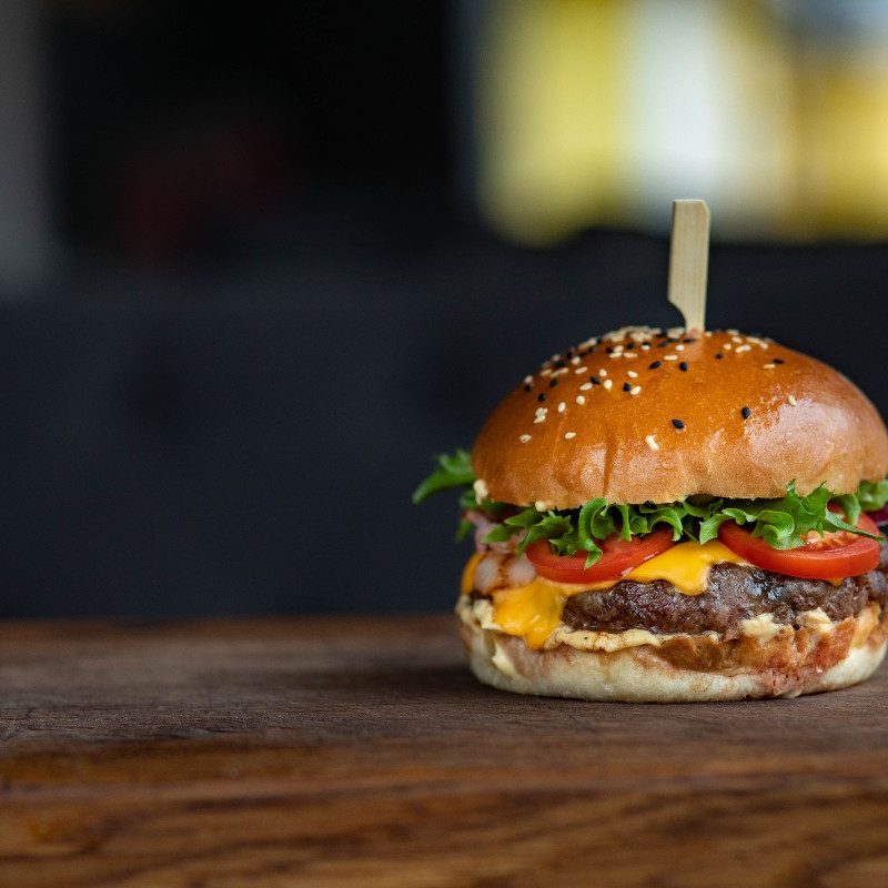A hamburger on a wooden table