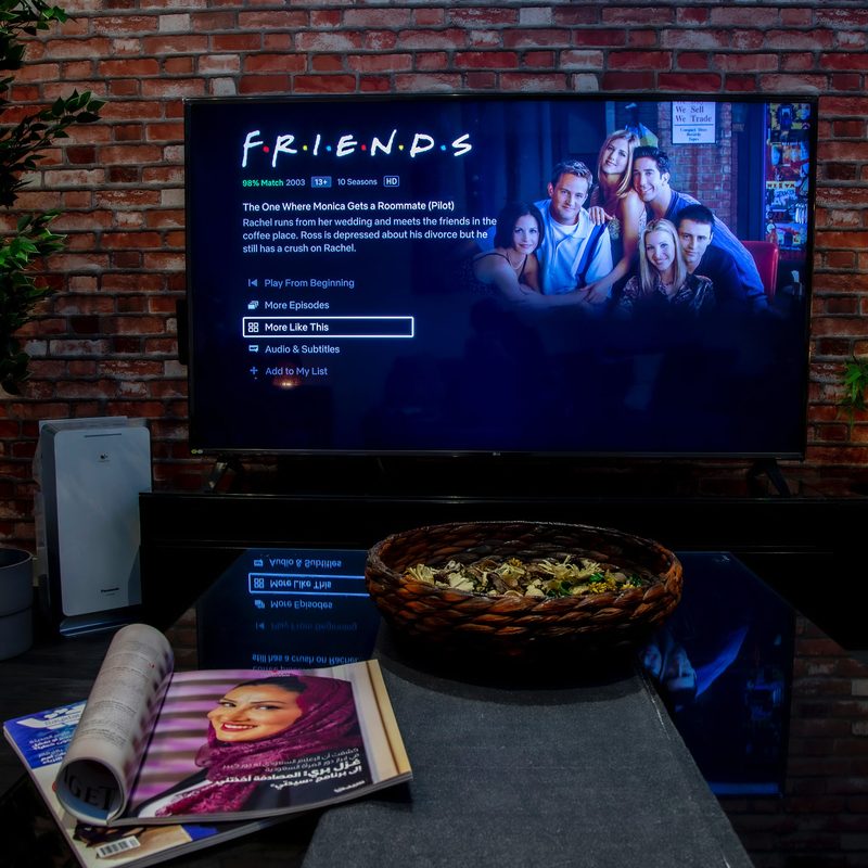 living room with Friends on TV screen