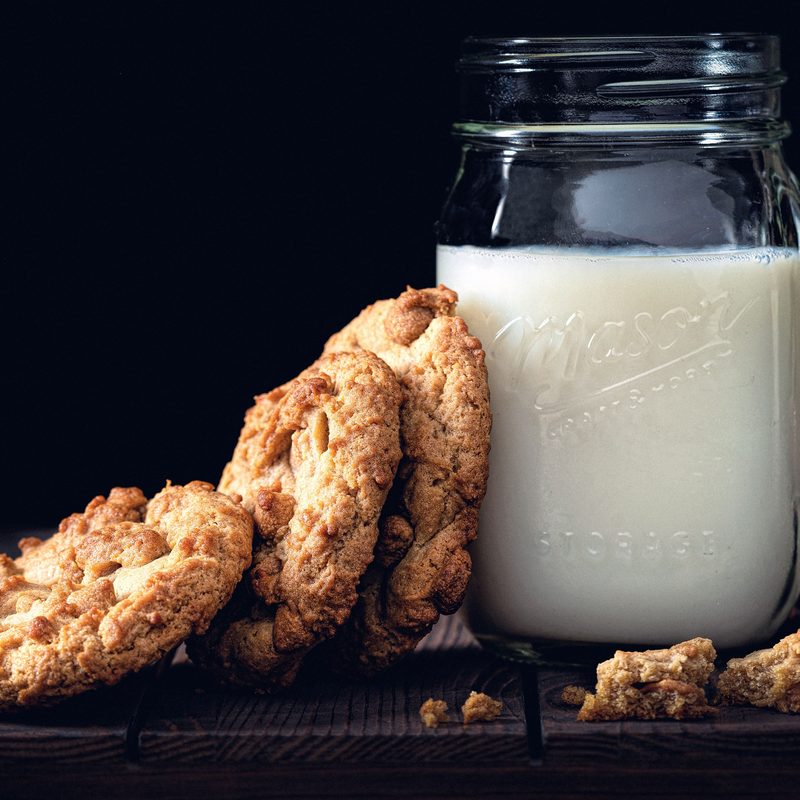 Mason jar of milk next to a stack of cookies