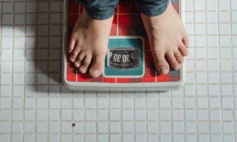 a person weighing themselves