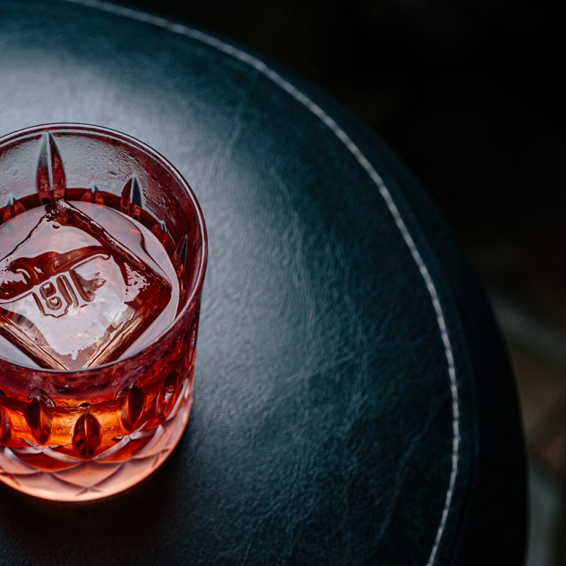 An Undetow cocktail on a barstool.