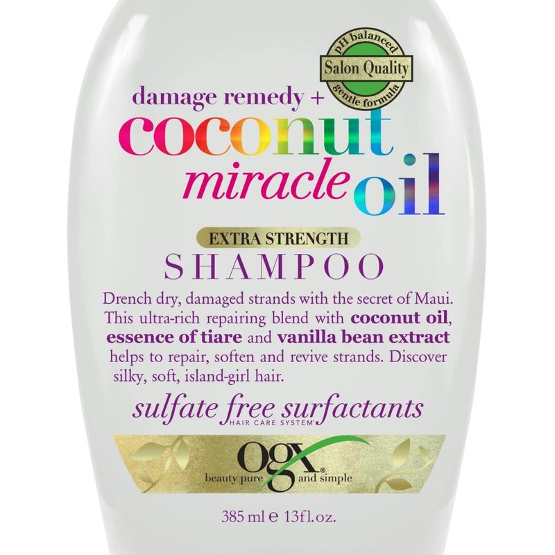A close-up of a bottle of OGX Extra Strength Damage Remedy + Coconut Miracle Oil Repairing Daily Shampoo.