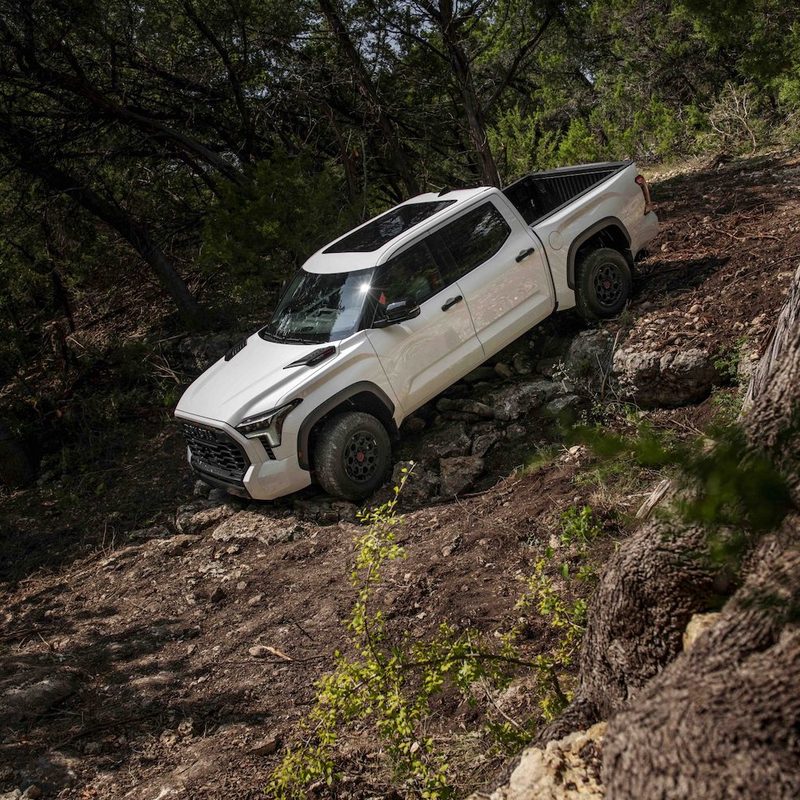 2023 Toyota Tundra TRD Pro front end from driver's side driving down a steep decline on a rough trail.