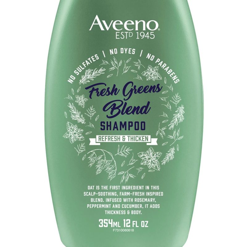 A close-up of a bottle of Aveeno Scalp Soothing Fresh Greens Blend Shampoo