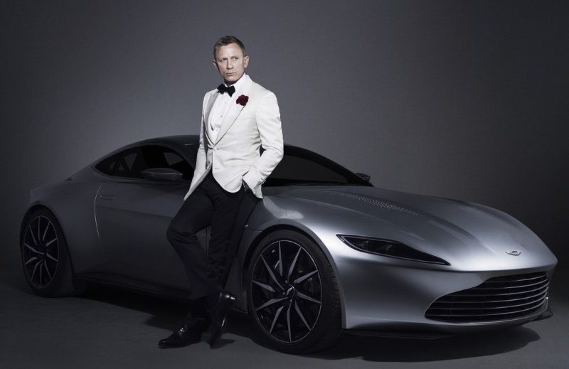 James Bond leaning on Aston Martin
