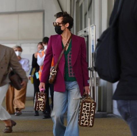 Harry Styles in a magenta blazer and baggy jeans