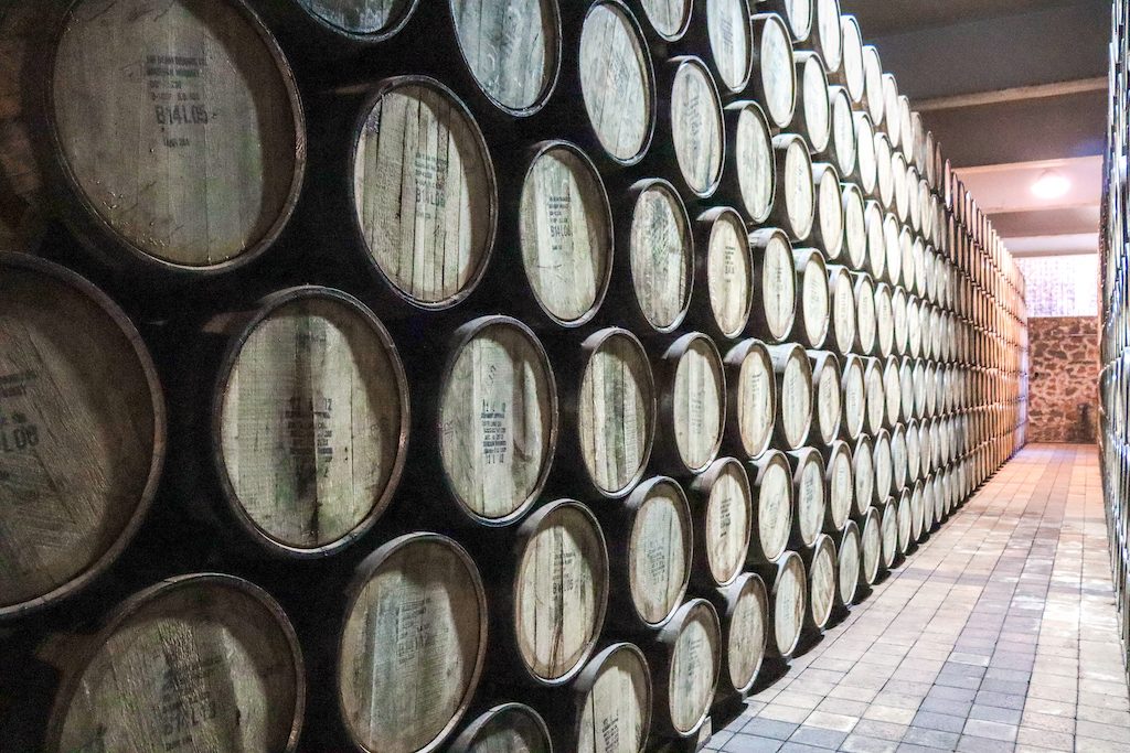 Dozens of barrels stacked on top of one another