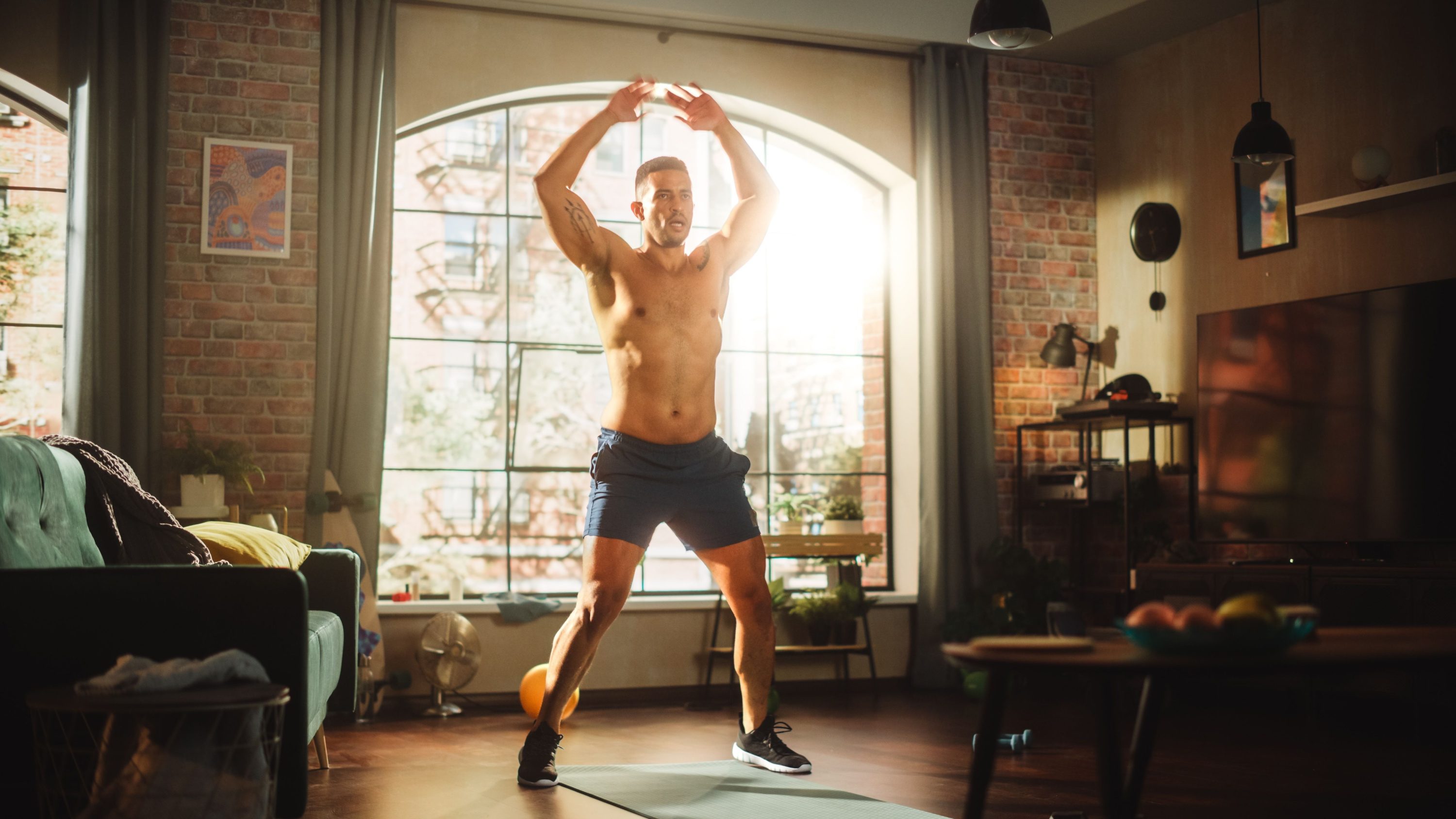 Man doing jumping jacks outside