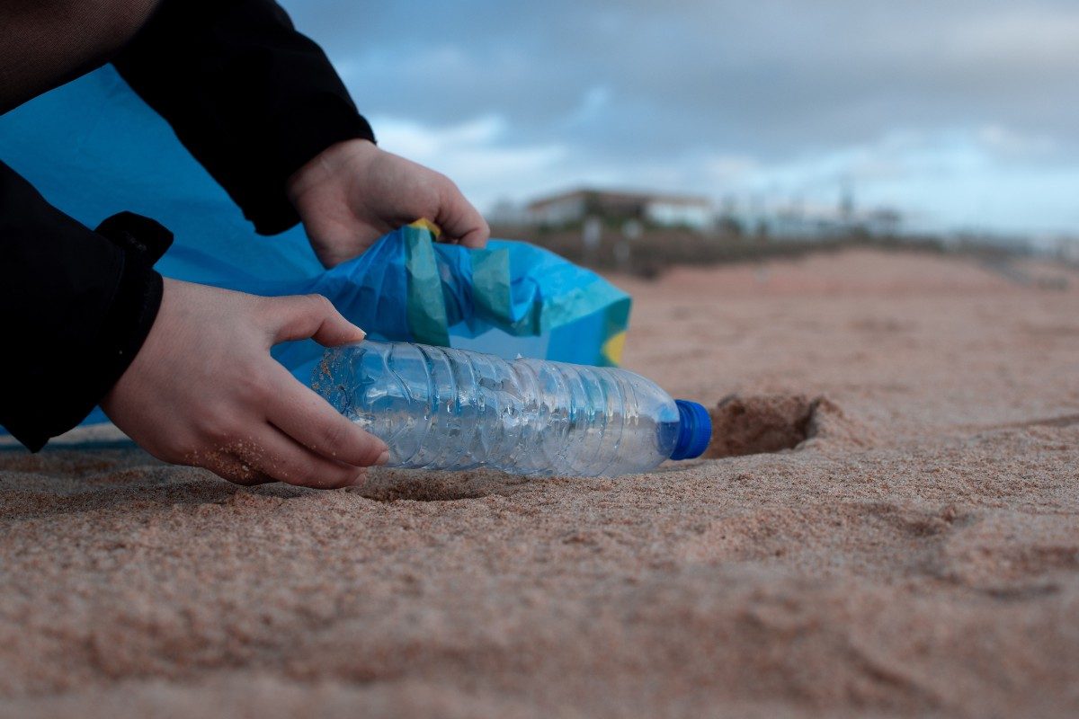 a person cleaning a beach