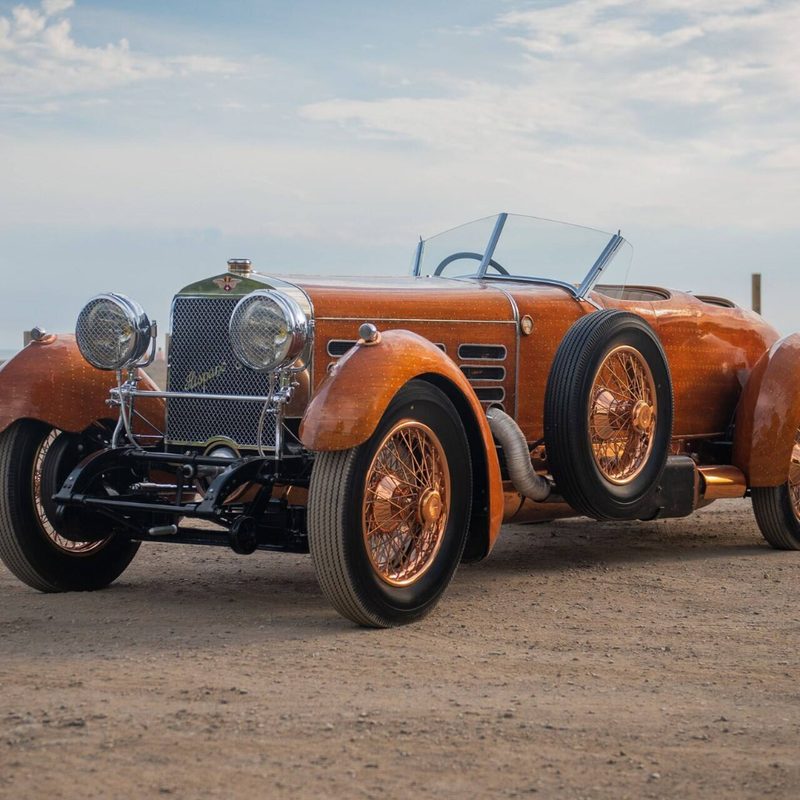 1924 Hispano-Suiza H6C “Tulipwood” Torpedo front end angle from driver's side parked in a dirt field.