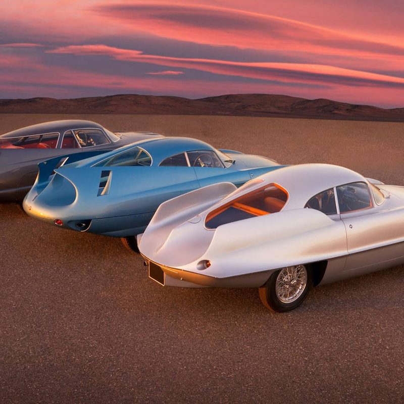 1953 Alfa Romeo Alfa BAT Cars rear end angle on a dirt trail in front of mountains during sunset.