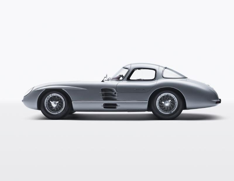1955 Mercedes-Benz SLR “Uhlenhaut Coupé” 2 side profile in front of a white studio wall.