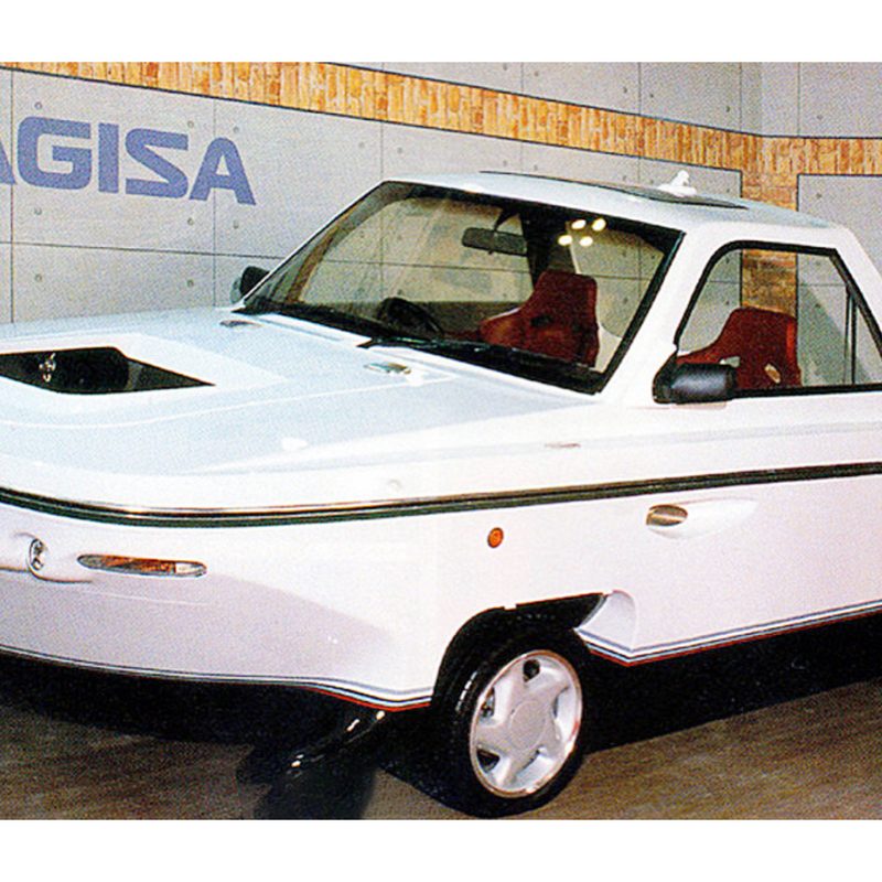 1991 Isuzu Nagisa front end angle sitting on a platform in front of a display.