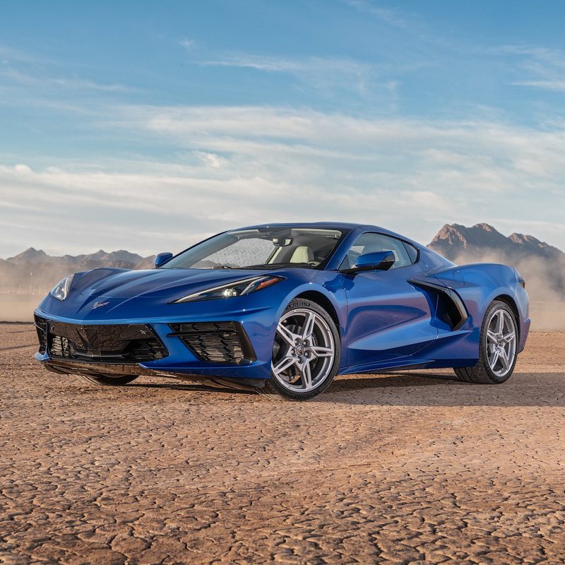 2020 Chevrolet Corvette Stingray front end angle from driver's side in the desert in front of mountains.