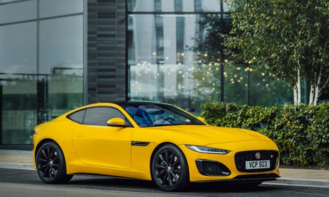 2022 Jaguar F-Type front end angle from passenger's side parked on the side of a street with a glass building in the background.