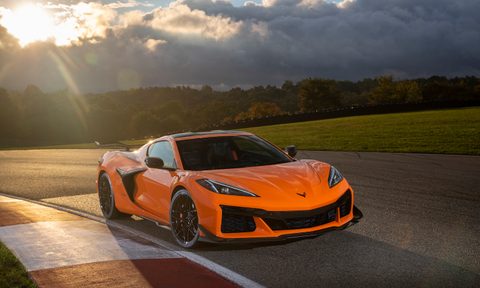 2023 Chevrolet Corvette Z06 front end angle passenger's side parked on a track with dark clouds in the back.