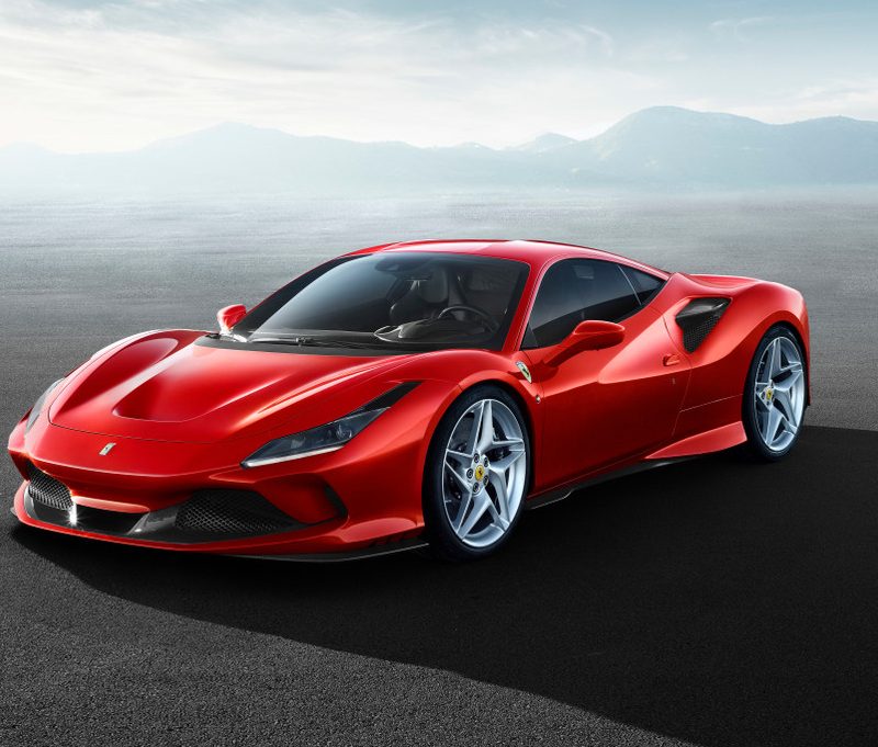 Front end angle of 2023 Ferrari F8 Tributo parked in front of mountains in the distance.