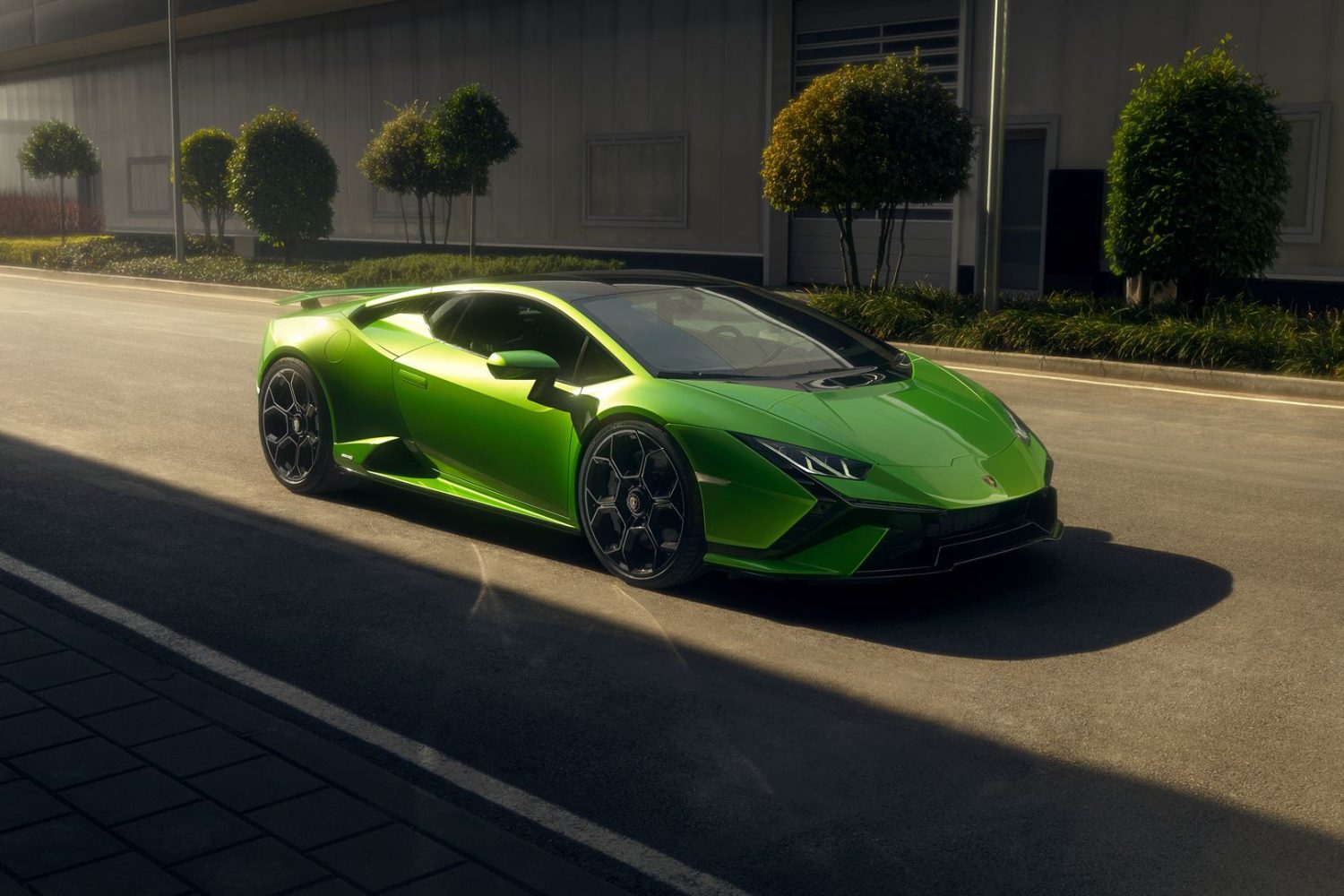2023 Lamborghini Huracan Tecnica front end angle from passenger's side parked on the road with buildings in the back.