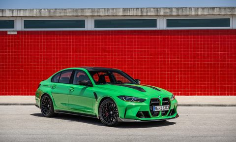 2024 BMW M3 CS front end angle from passenger side parked on a racetrack.