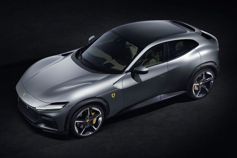 2024 Ferrari Purosangue overhead shot of side profile from driver's side in front of a black background.