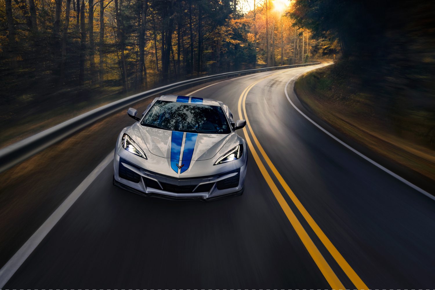 Front end close up of 2024 Chevrolet Corvette E-Ray driving on a windy road.