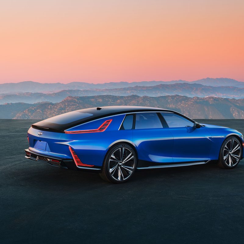 Cadillac Celestiq rear end angle from passenger's side in front of a sunset with mountains in the back.