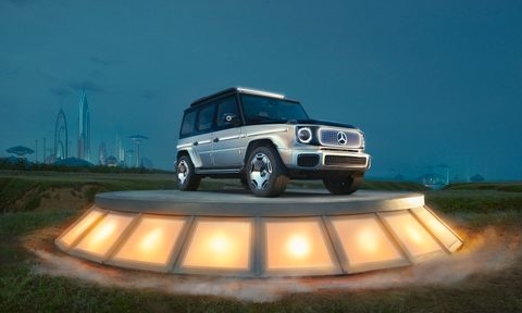 Mercedes-Benz EQG front end angle from passenger's side on a platform in front of a futuristic skyline
