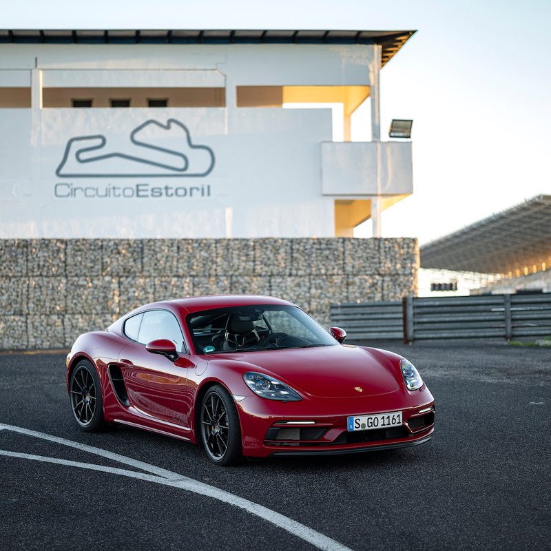 Porsche 718 Cayman GTS 4.0 front end angle from passenger's side parked on a race track.
