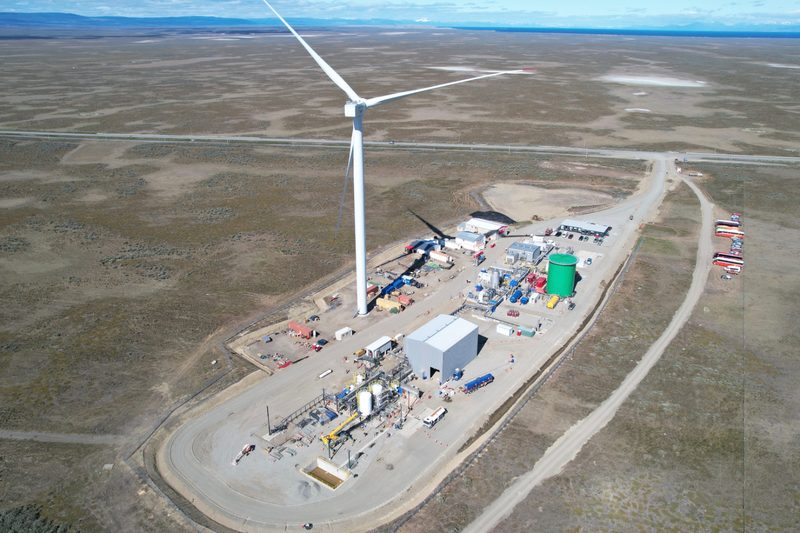 Porsche's eFuel Plant in Chile overhead photo with wind turbine in the front.