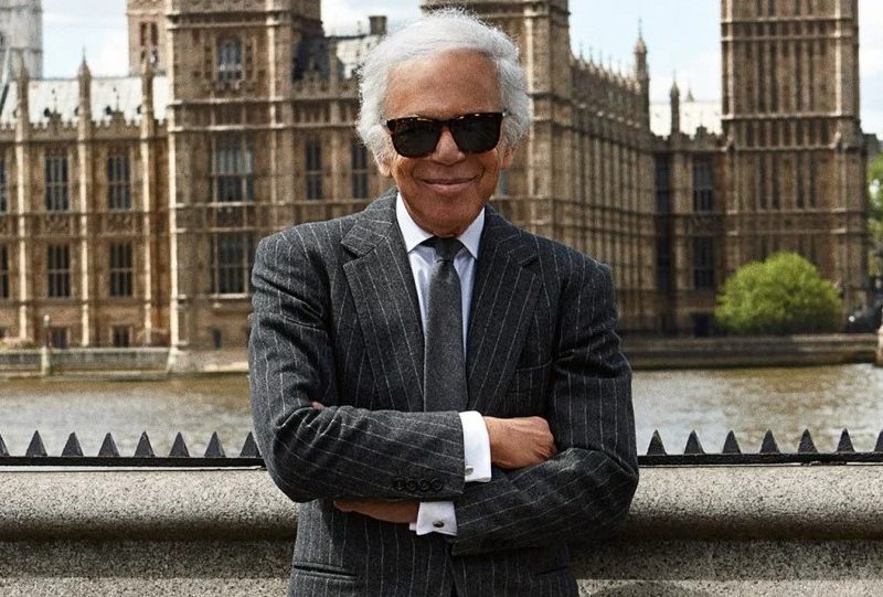 Ralph Lauren standing in front of a palace in a suit
