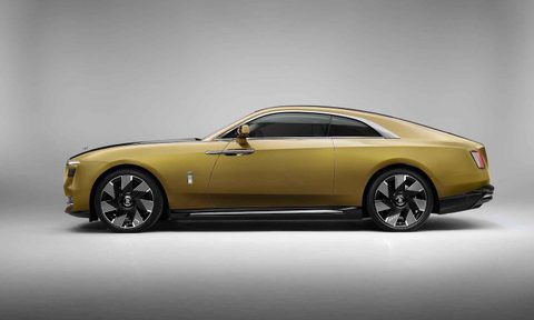 Rolls-Royce Spectre side profile in front of gray walls and studio lighting.